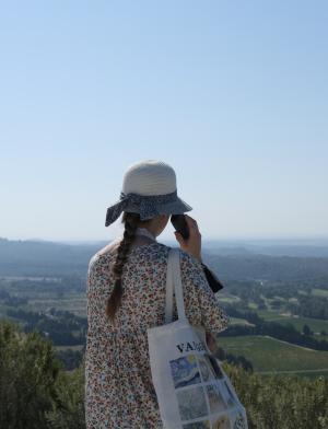 A student looks out over the green landscape of Beaux de Provence, France.