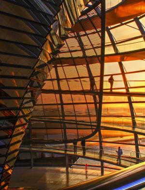 people walking in the dome atop the Reichstag building during sunset