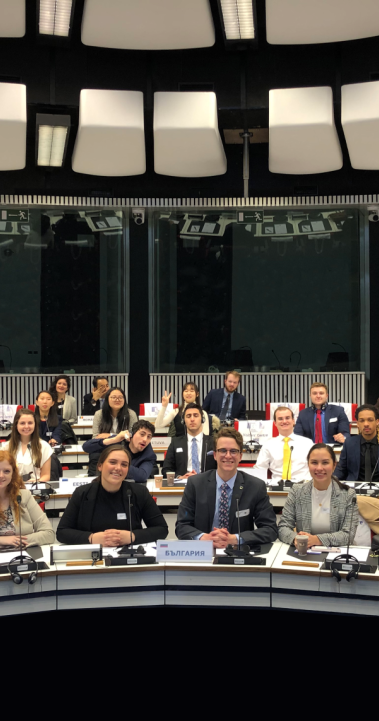Students sit in three rows and look at the camera as they take part in a Model EU 