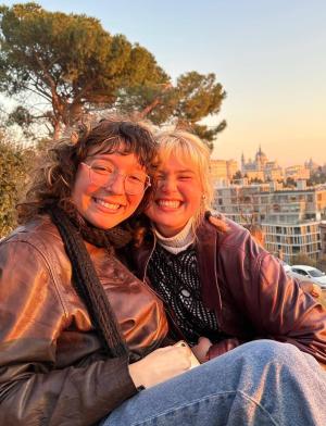 Two students sit high above the city.