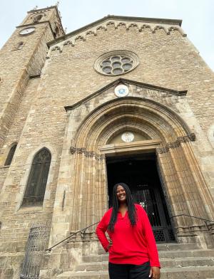 an IES Intern standing in front of her internship placement at a typical European building