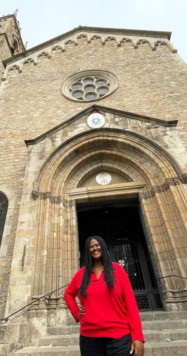 an IES Intern standing in front of her internship placement at a typical European building