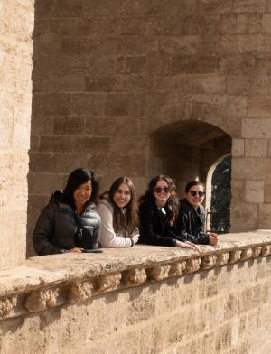 A group of students hang out at the top of a building overlooking the city in Madrid, Spain.